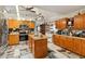 Bright kitchen featuring an island, stainless steel appliances, and wood cabinets at 50 2Nd St, Saint Cloud, FL 34769