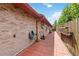 Brick paved side yard with lawnmower and ladder at 50 2Nd St, Saint Cloud, FL 34769