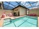 Private screened-in pool with patio furniture and grill at 9047 Rhodes St, Kissimmee, FL 34747