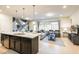 Open concept kitchen and living area with breakfast bar and island at 9047 Rhodes St, Kissimmee, FL 34747