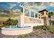 Community entrance sign with water fountain and pergola at 9047 Rhodes St, Kissimmee, FL 34747