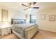 Spacious bedroom with a king-size bed and ceiling fan at 9047 Rhodes St, Kissimmee, FL 34747
