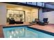 Night view of inviting pool area with patio furniture and view into the home at 9047 Rhodes St, Kissimmee, FL 34747