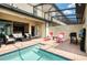 Private pool and patio with seating and grill at 9047 Rhodes St, Kissimmee, FL 34747
