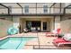 Relaxing pool area with patio furniture, covered lanai, and a refreshing pool at 9047 Rhodes St, Kissimmee, FL 34747