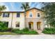 Two-story townhouse with a brick walkway and lush landscaping at 9047 Rhodes St, Kissimmee, FL 34747
