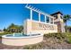 Community entrance sign with water fountain and pergola at 9047 Rhodes St, Kissimmee, FL 34747