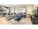 Cozy living room featuring a sofa, armchairs, and a large TV at 9047 Rhodes St, Kissimmee, FL 34747