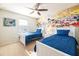 Two twin beds, ceiling fan, and a mural of Disney characters at 9047 Rhodes St, Kissimmee, FL 34747