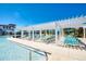 Inviting pool area with a pergola and plentiful lounge chairs at 9047 Rhodes St, Kissimmee, FL 34747