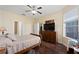 Bright bedroom with large window, hardwood floors, and ceiling fan at 3222 Stonehurst Cir, Kissimmee, FL 34741