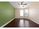 Well-lit bedroom with dark hardwood floors and a ceiling fan at 3222 Stonehurst Cir, Kissimmee, FL 34741