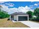 New construction home with a black garage door at 48 Atlantic Ave, Babson Park, FL 33827