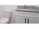 Bathroom with white vanity, granite countertop, and black hardware at 48 Atlantic Ave, Babson Park, FL 33827