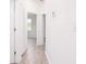 Bright hallway with doors to bedrooms and vinyl flooring at 48 Atlantic Ave, Babson Park, FL 33827