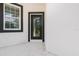 Modern black front door with glass panel at 48 Atlantic Ave, Babson Park, FL 33827