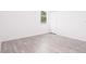 Simple bedroom with wood-look flooring and window at 48 Atlantic Ave, Babson Park, FL 33827