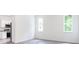 Bright living room with kitchen and wood floors at 48 Atlantic Ave, Babson Park, FL 33827