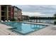 Community pool with lounge chairs and a pergola at 2203 Key West Ct # 436, Kissimmee, FL 34741