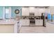 Modern kitchen with white cabinets, granite countertops, and stainless steel appliances at 1495 Rolling Fairways Dr, Davenport, FL 33896