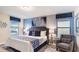Primary bedroom with king bed and sitting chair at 1495 Rolling Fairways Dr, Davenport, FL 33896