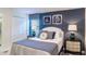 Bright bedroom with a queen-size bed and stylish decor at 1495 Rolling Fairways Dr, Davenport, FL 33896