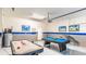 Game room with pool table, air hockey, and bar seating at 1495 Rolling Fairways Dr, Davenport, FL 33896