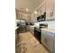 Modern kitchen with stainless steel appliances and gray cabinetry at 718 Longboat Dr, Davenport, FL 33896