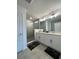 Main bathroom with double vanity, a large shower, and gray tile flooring at 718 Longboat Dr, Davenport, FL 33896