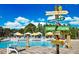 Resort-style pool with umbrellas and a whimsical sign at 718 Longboat Dr, Davenport, FL 33896