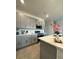 Modern kitchen with gray cabinets, quartz countertops, and stainless steel appliances at 718 Longboat Dr, Davenport, FL 33896