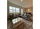 Comfortable living room with sectional sofa and large window at 718 Longboat Dr, Davenport, FL 33896