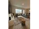 Living room boasts a sectional sofa and stylish decor at 718 Longboat Dr, Davenport, FL 33896