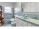 Retro bathroom with light blue tile, shower, and a vintage vanity at 1500 8Th Se St, Winter Haven, FL 33880