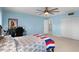 Blue bedroom with a bed, desk, and closet at 1500 8Th Se St, Winter Haven, FL 33880