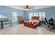 Bedroom with a bed, desk, and large windows at 1500 8Th Se St, Winter Haven, FL 33880