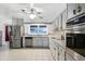 Modern kitchen with stainless steel appliances and granite countertops at 1500 8Th Se St, Winter Haven, FL 33880