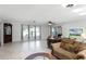 Open living room with tile floors and large windows at 1500 8Th Se St, Winter Haven, FL 33880