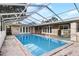 Inviting screened-in pool with patio and surrounding fence at 1500 8Th Se St, Winter Haven, FL 33880
