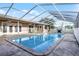 Inviting screened-in pool with patio and surrounding fence at 1500 8Th Se St, Winter Haven, FL 33880