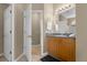 Clean bathroom with wood cabinets and updated vanity at 476 Calabay Parc Blvd, Davenport, FL 33897