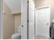 Small bathroom with toilet and access to laundry at 476 Calabay Parc Blvd, Davenport, FL 33897
