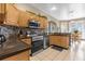 Kitchen with stainless steel appliances and wood cabinets at 476 Calabay Parc Blvd, Davenport, FL 33897