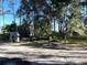 Large backyard with mature trees and a small shed at 6790 Bass Hwy, St Cloud, FL 34771