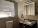Bathroom with vanity, medicine cabinet, and toilet at 6790 Bass Hwy, St Cloud, FL 34771