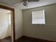 Bedroom with ceiling fan, window, and access to another room at 6790 Bass Hwy, St Cloud, FL 34771