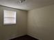 Simple bedroom with carpet, window blinds, and a single window at 6790 Bass Hwy, St Cloud, FL 34771