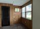 Bedroom with wood paneling, window, and closet at 6790 Bass Hwy, St Cloud, FL 34771