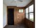 Bedroom with wood paneling, window, and closet at 6790 Bass Hwy, St Cloud, FL 34771