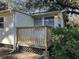 House exterior showcasing a newly built wooden deck and surrounding landscape at 6790 Bass Hwy, Saint Cloud, FL 34771